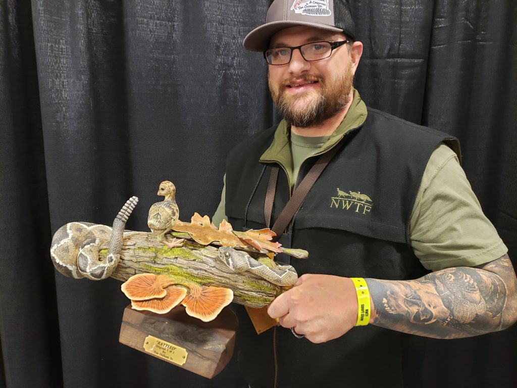 Call Maker of the Year holding his prize-winning call at NWTF's 46 Convention  