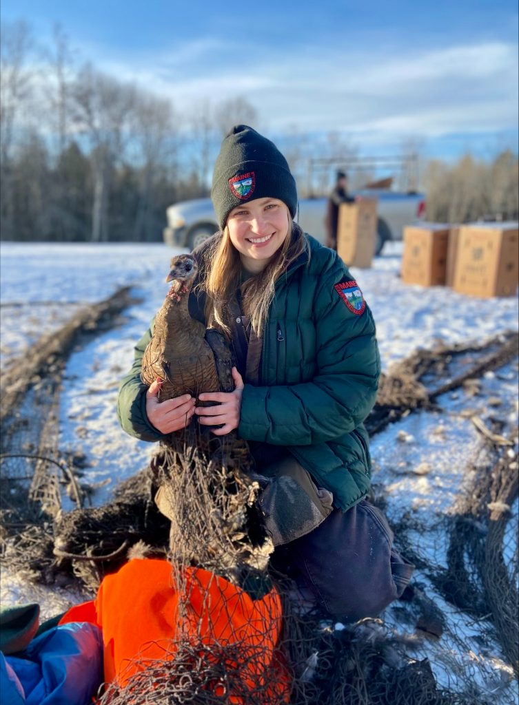 Maine Staff posing with wild turkey 