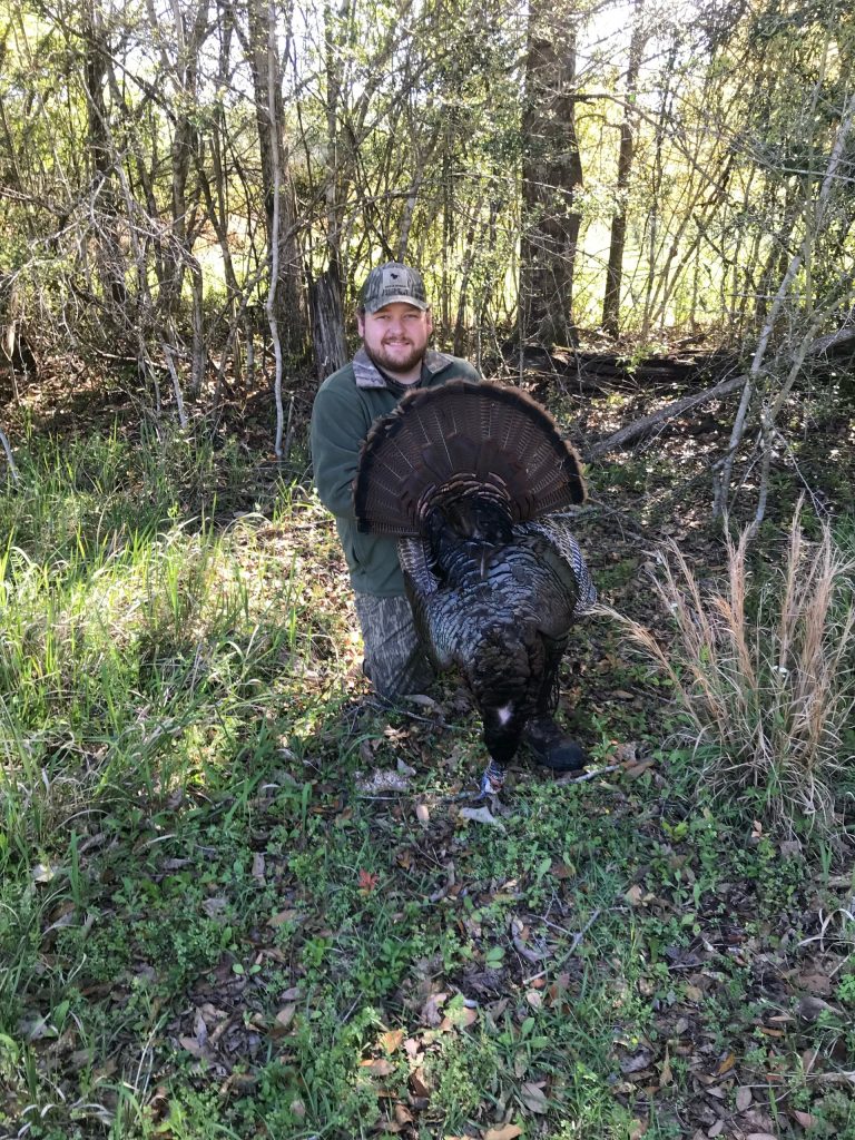hunter with a turkey he harvested