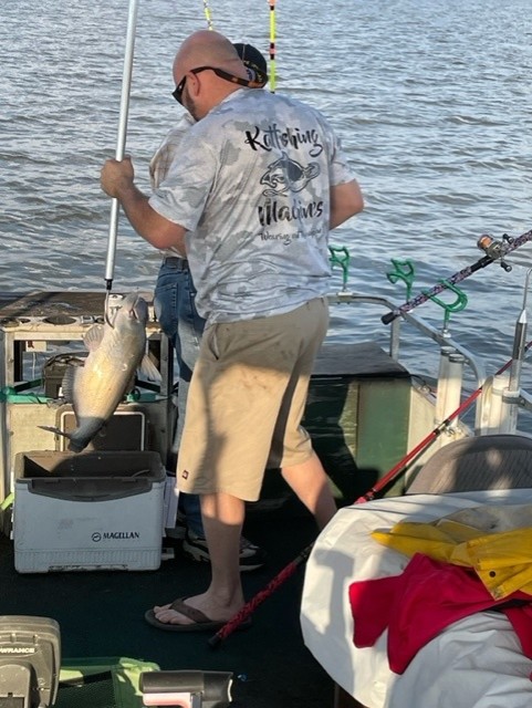 fisherman putting catfish in the cooler