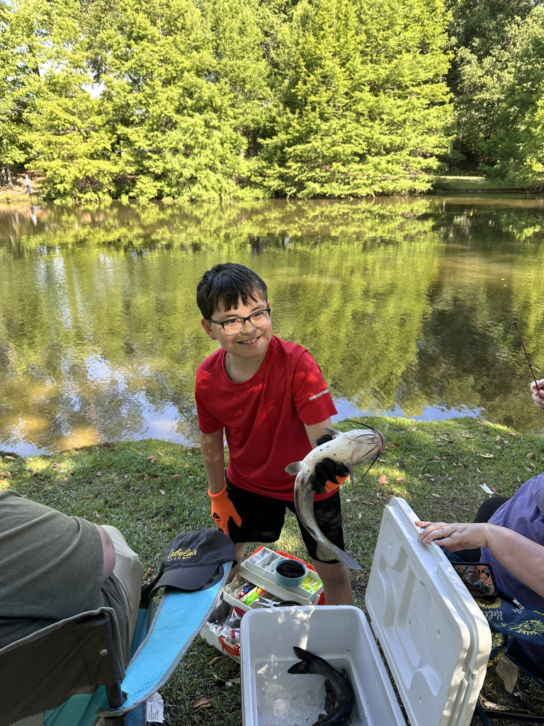 kid holding a catfish