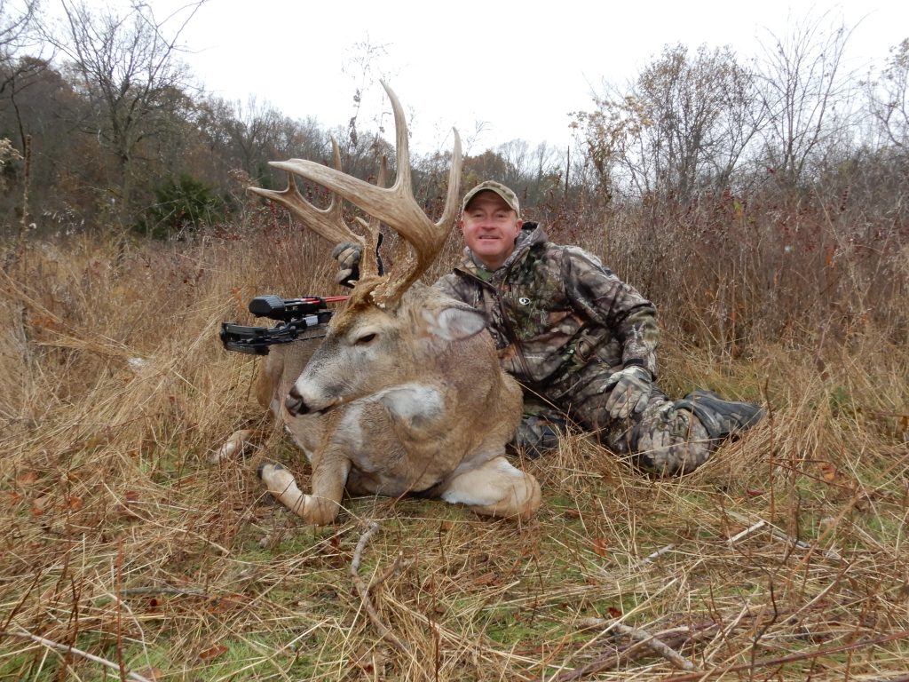 Hunter with harvested mature deer