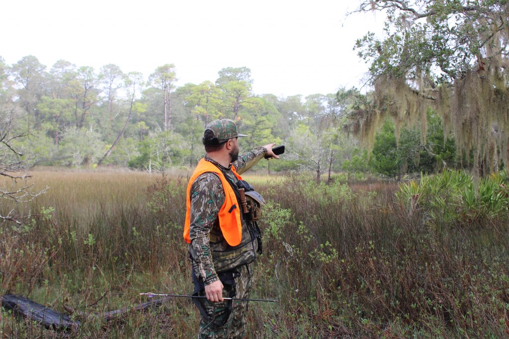 A hunter looks down range at his deer he just harvested in the South Carolina Lowcountry.