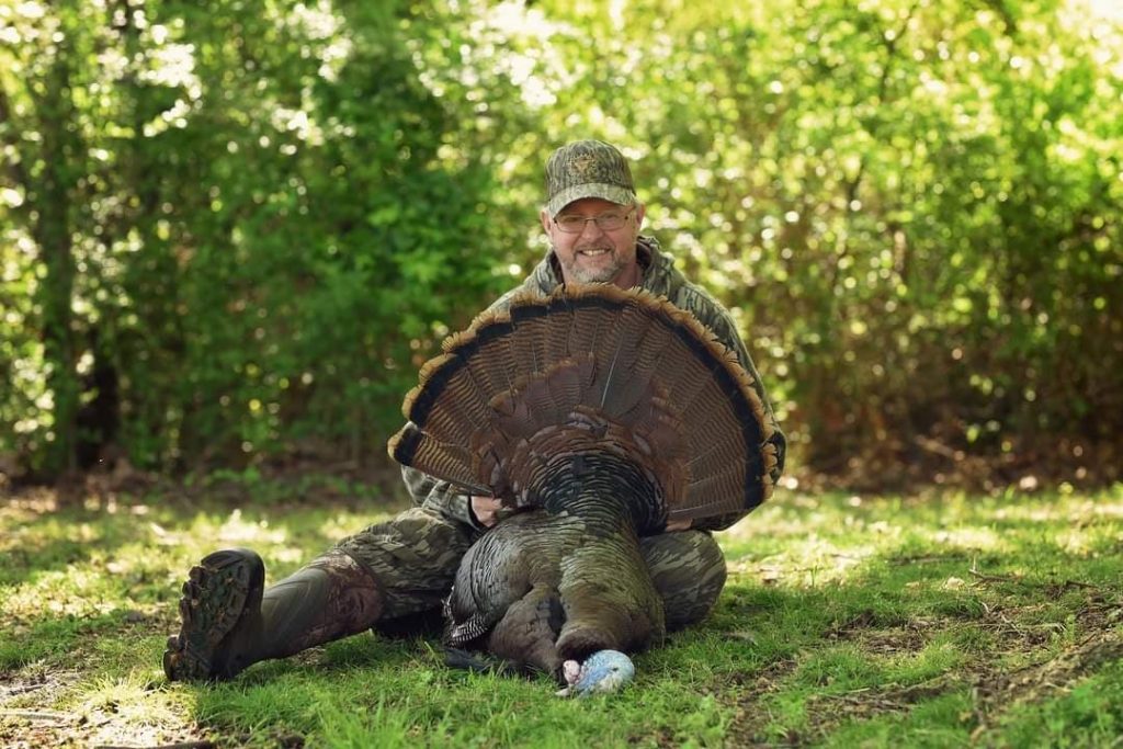 Jim Pollard with a harvested wild turkey.