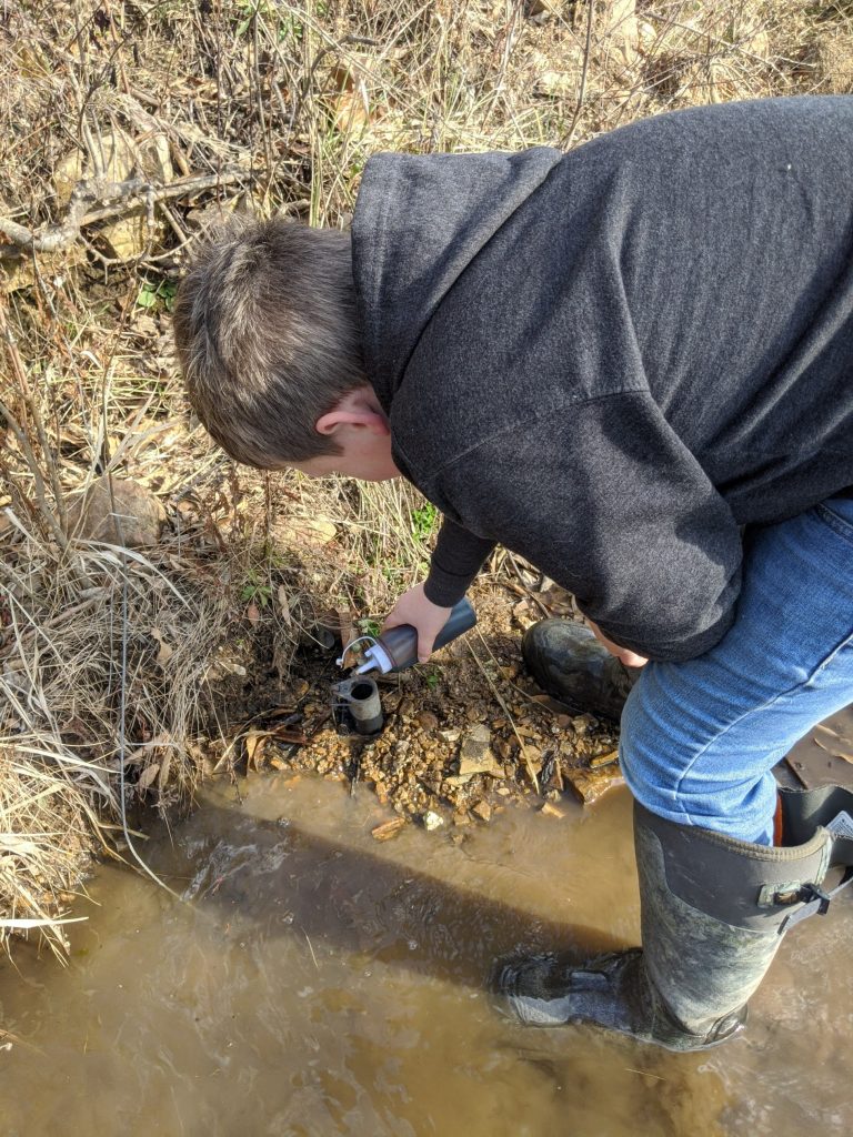 A youth hunter sets a dog-proof trap