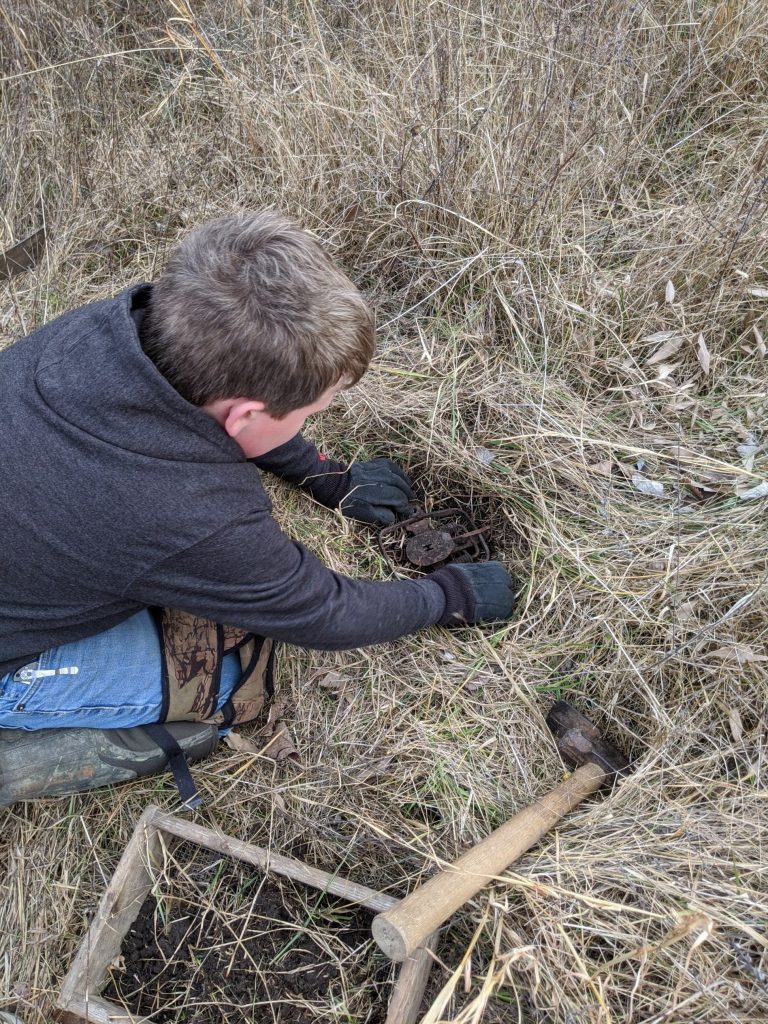 a youth trapper sets a trap. 