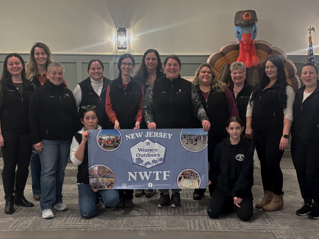New Jersey WITO members pose with chapter banner.