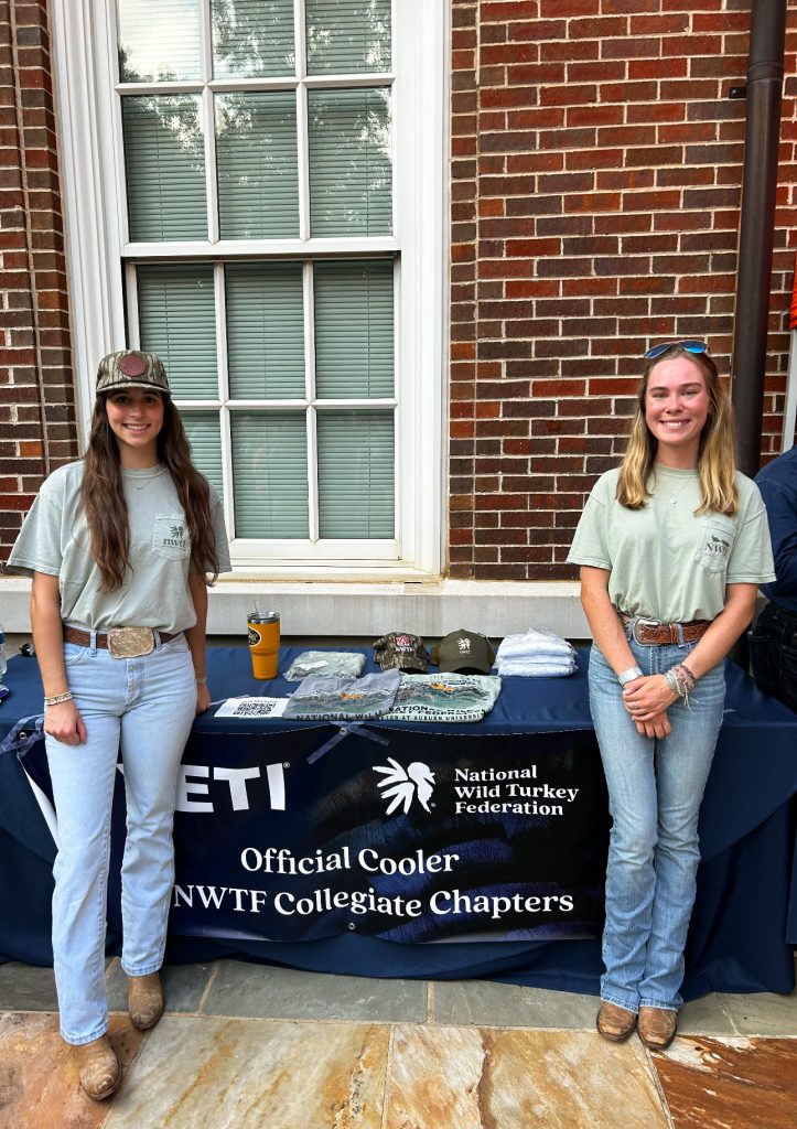 Two college students standing in front of NWTF College table