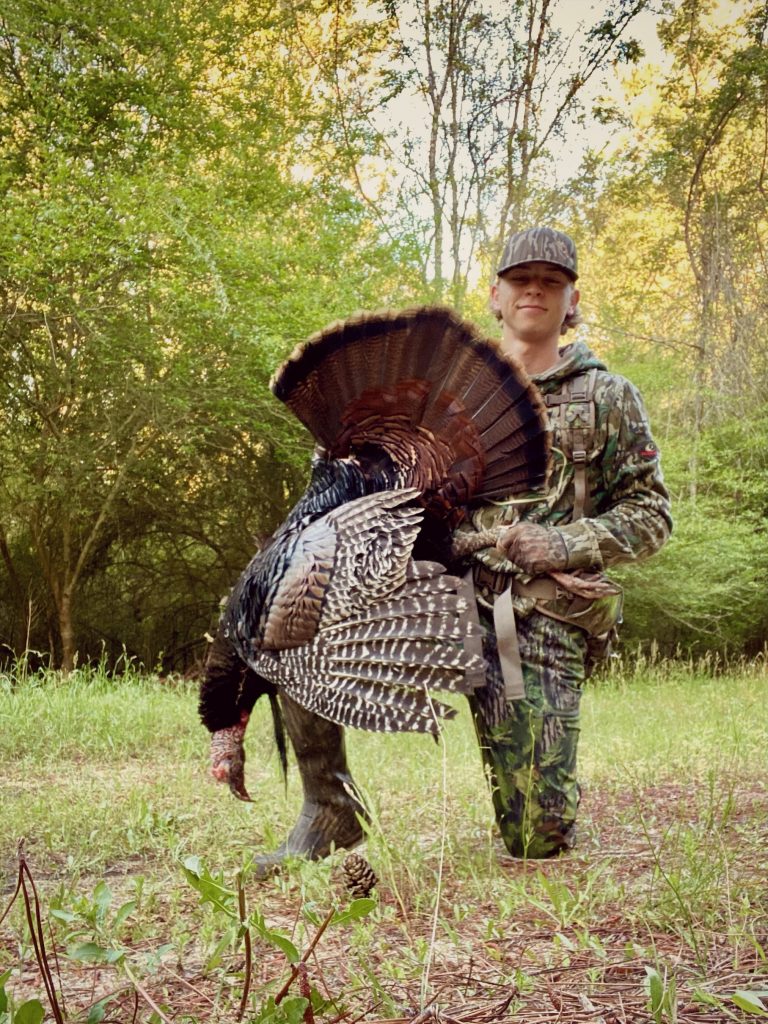 Chance Wiggins with harvested turkey