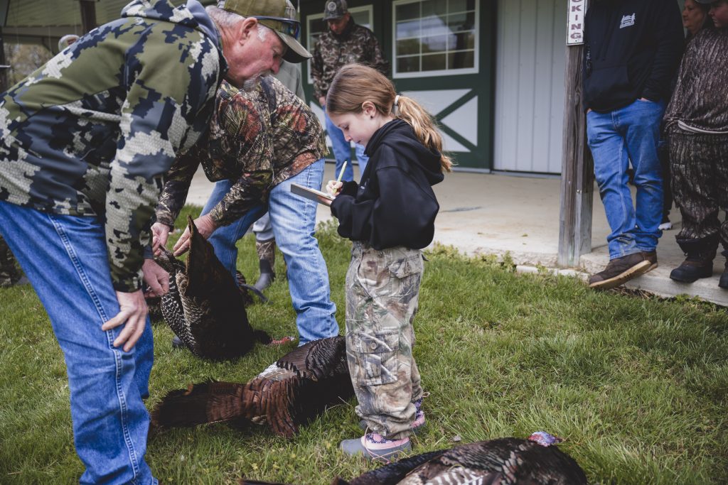 Youth measuring turkey