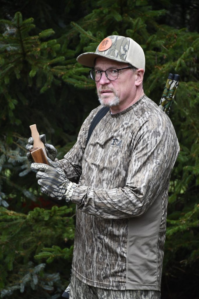 A hunter using a turkey call. 