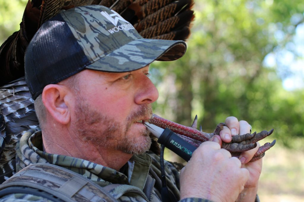 A junter uses a turkey call.