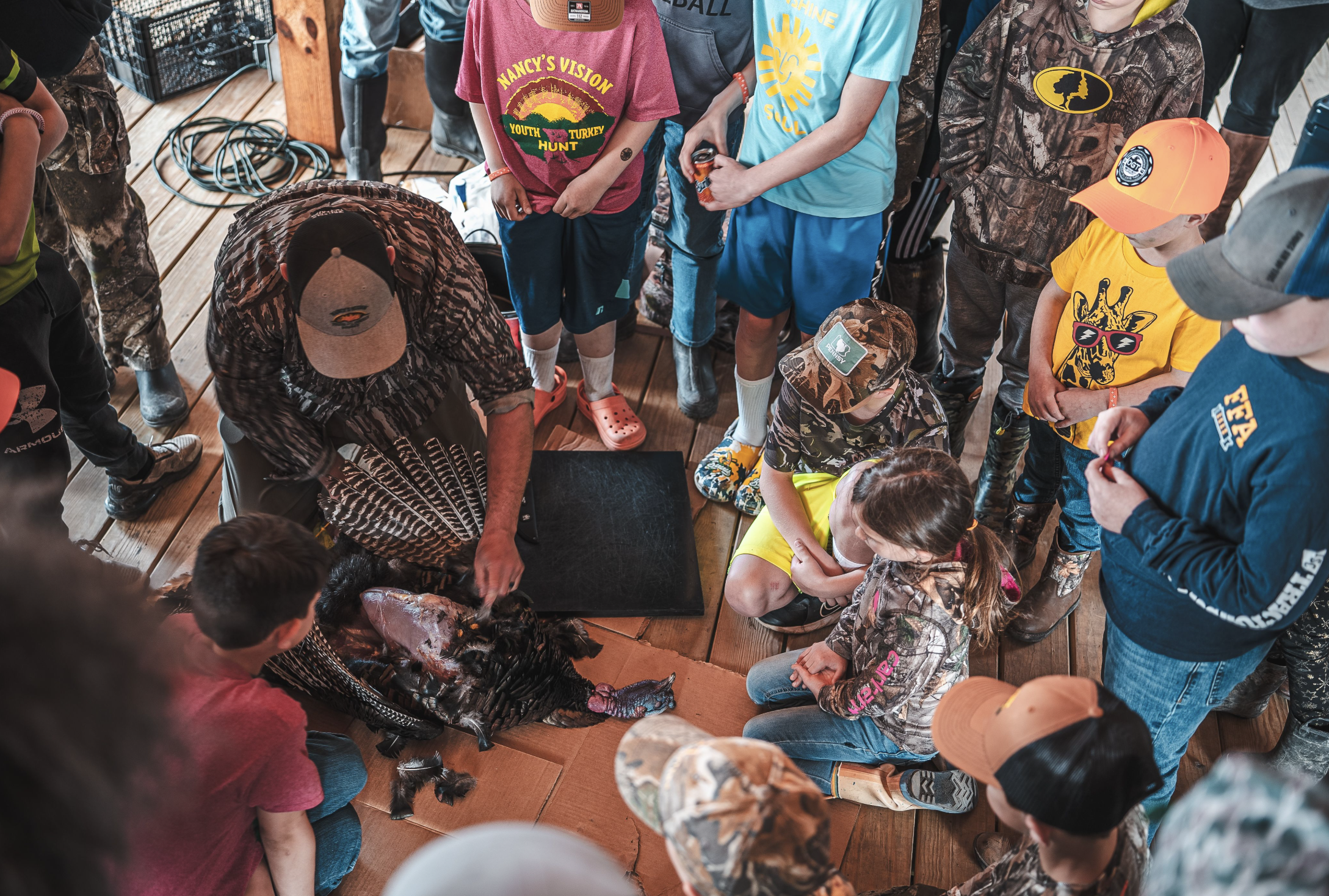 Youth gather around bird during Field to Fork 