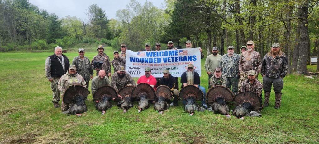 Veterans and mentors pose with their birds