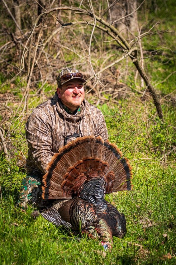 A hunter celebrates his harvest. 