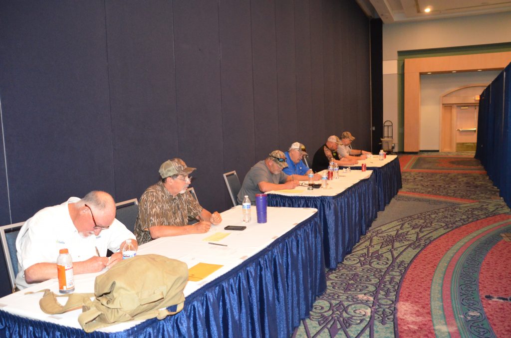 The panel of judges sat sequestered behind a curtain to do the scoring. Before each competition, every caller received a different number. The judges did not know the identities of any of the competitors as they evaluated each call by the number. Photo Credit: John N. Felsher.