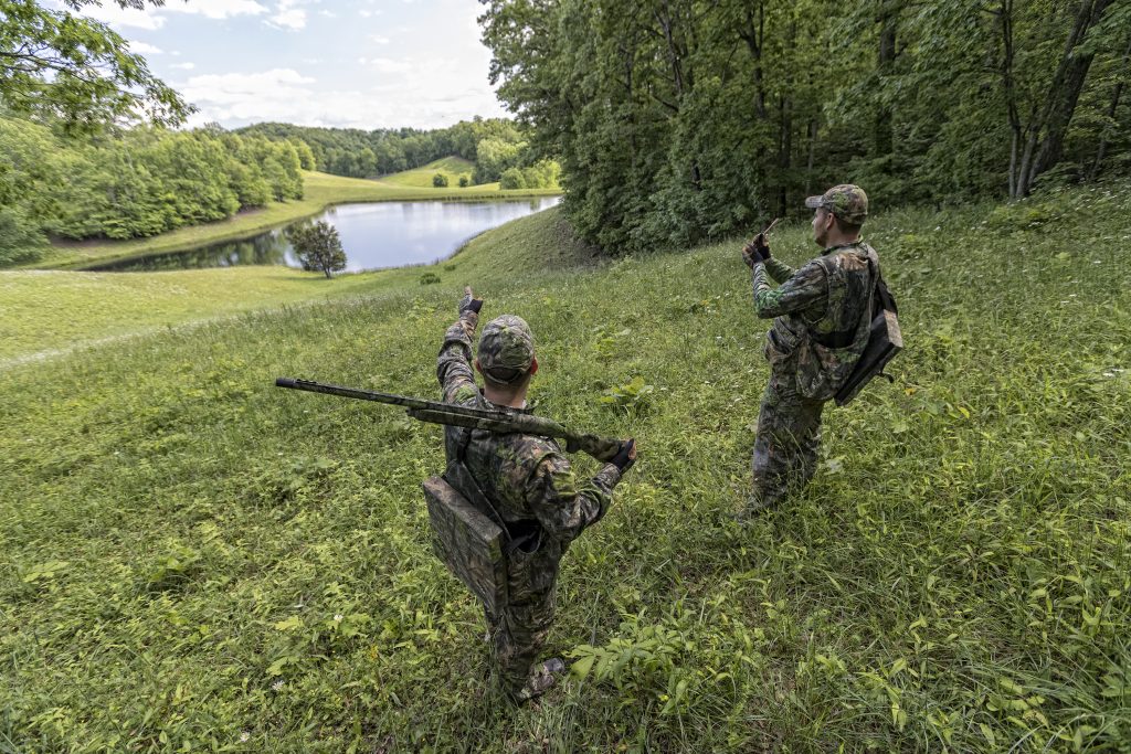 Hunters look to a nearby pond to plan their hunt. 
