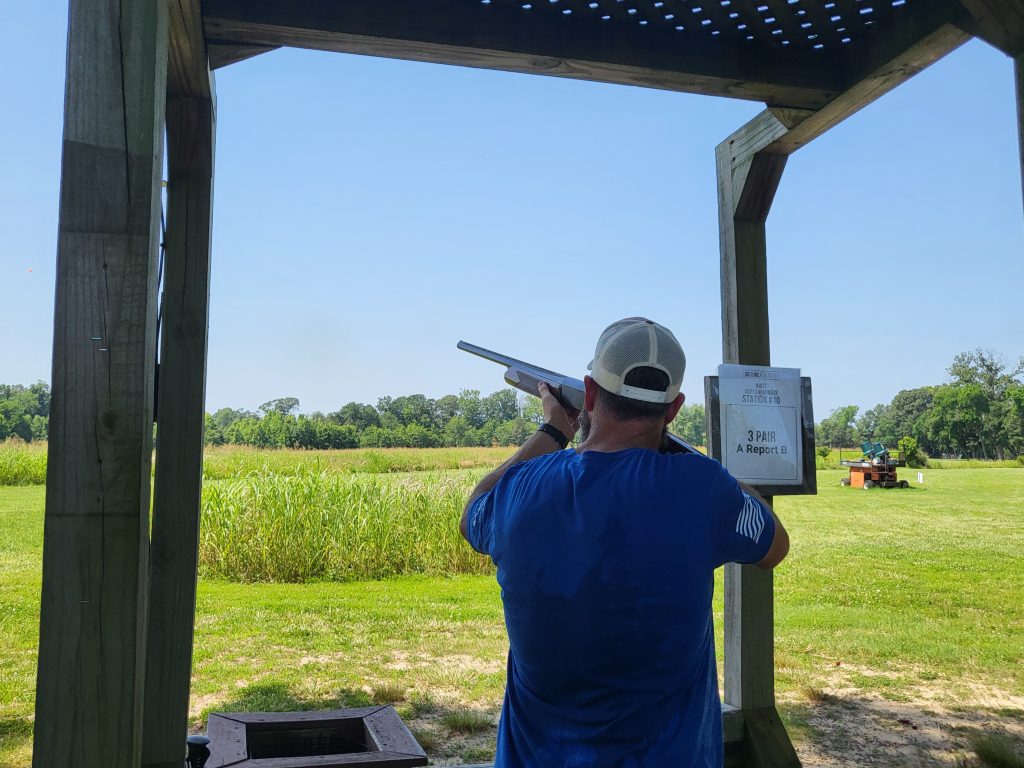 Participant shooting a shotgun.