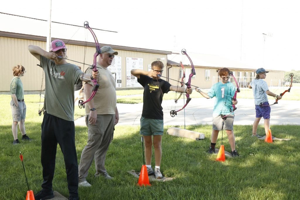 Participants in the Brandon Boss Gobblers Jakes event take their turn at shooting a bow and arrow as an instructor with the South Dakota Game, Fish & Parks looks on.