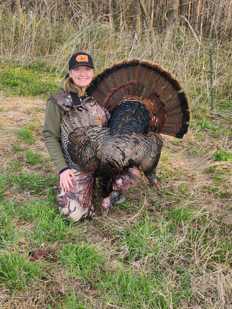 Shelby with a harvested wild turkey.