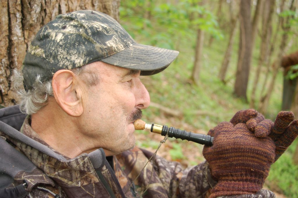 Hunter calls for a wild turkey