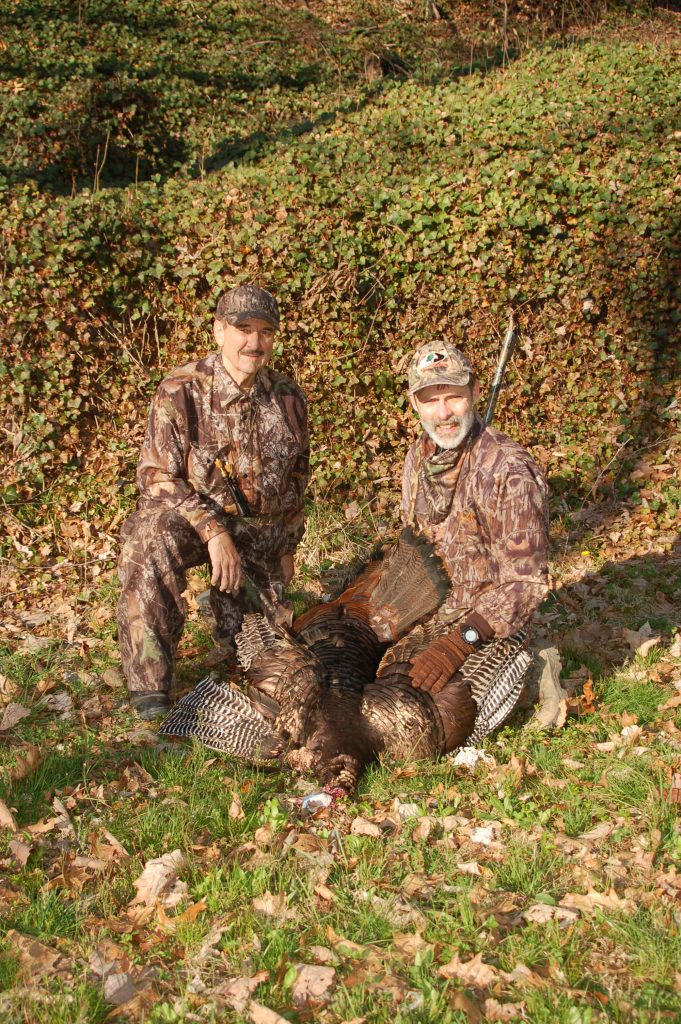 Hunters celebrate a wild turkey harvest.