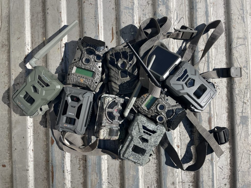 trail cameras piled up in a truck bed