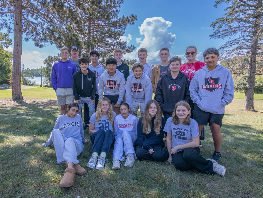 Student volunteers pose at event.