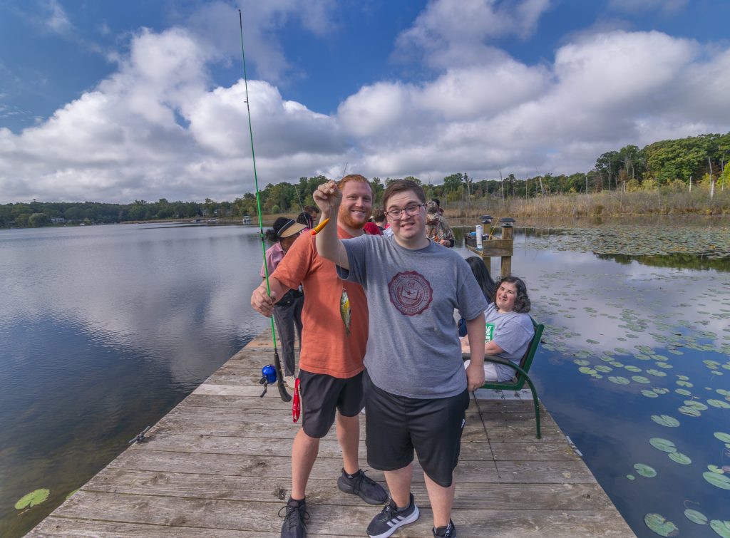 Mentor and youth catch a fish.