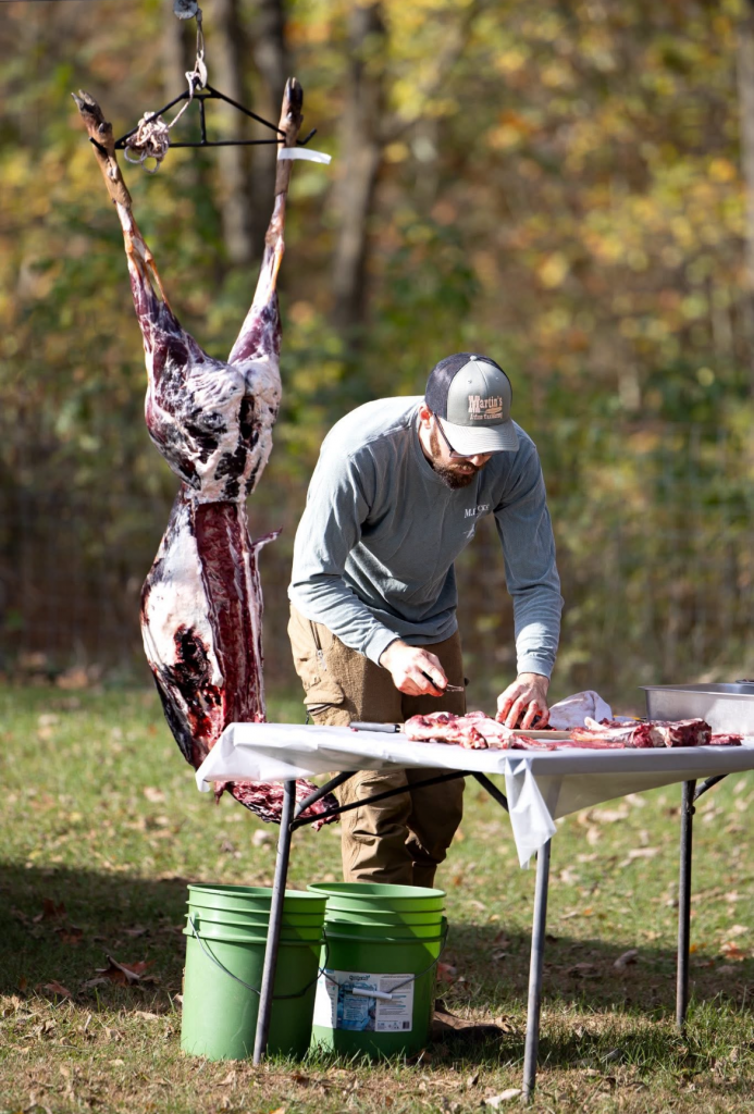 Volunteer leads deer processing course.