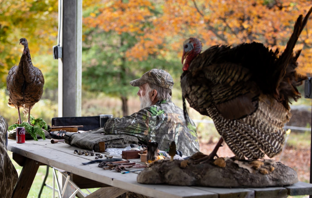 Volunteer hosts turkey hunting 101 station.