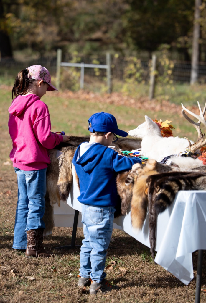 Two young kids look at taxidermy