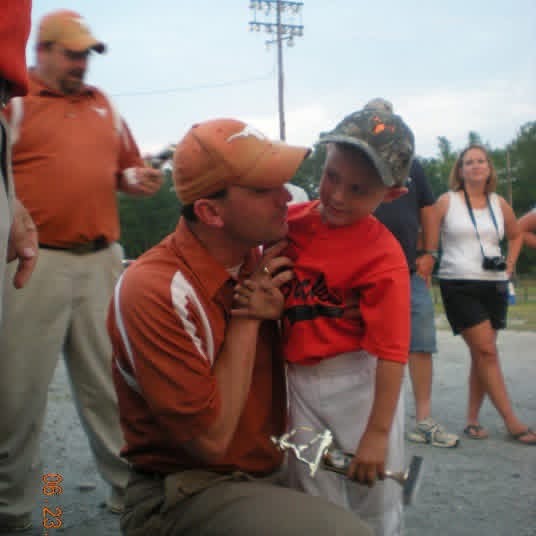 Young Carson and Mike at a baseball game